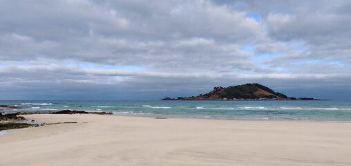 Fototapeta na wymiar Landscape of Hyeopjae beach with sand, mountain and cobalt blue sea
