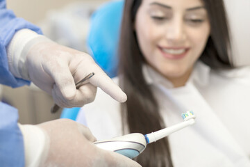 female dentist holding a toothbrush