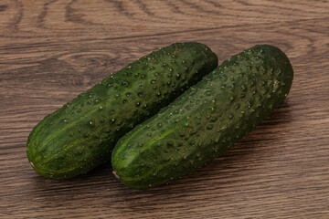 Green fresh cucumbers over background