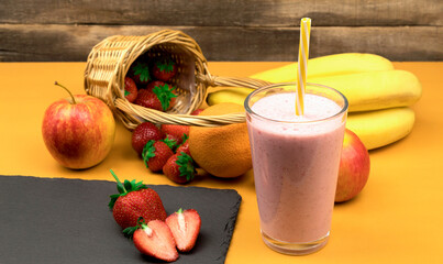 Side view of fruit milkshake with strawberries