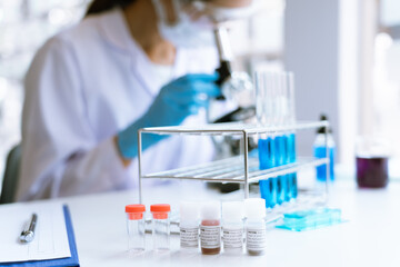 Fototapeta premium scientist in laboratory with test tubes