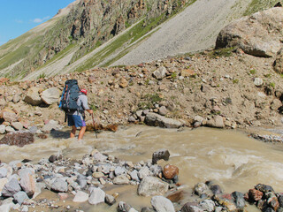 North Caucasus, Russia - July 17, 2008: Elbrus mountain summer view. Tourists cross the river
