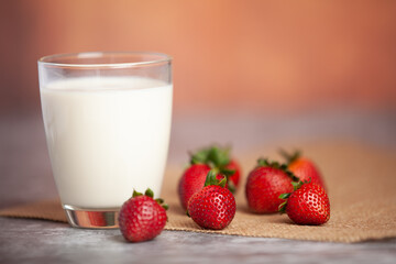 Strawberries arranged in pairs of bright white milk cups
