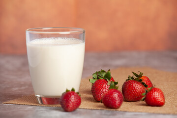 Strawberries arranged in pairs of bright white milk cups
