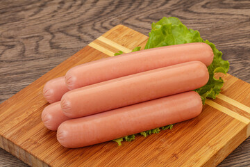 Tasty meat sausages over board