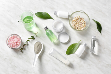 Natural cosmetics with ingredients on table