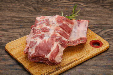 Raw pork ribs served rosemary