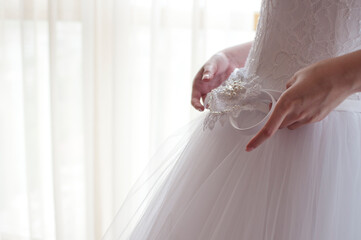 detail of the wedding dress, wedding photo of the bride in light colors