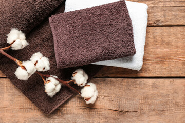 Fototapeta premium Cotton flowers and soft towels on wooden background
