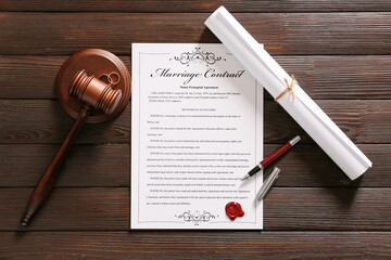 Marriage contract with judge gavel on wooden background