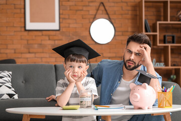 Little boy and father with savings for education and calculator at home