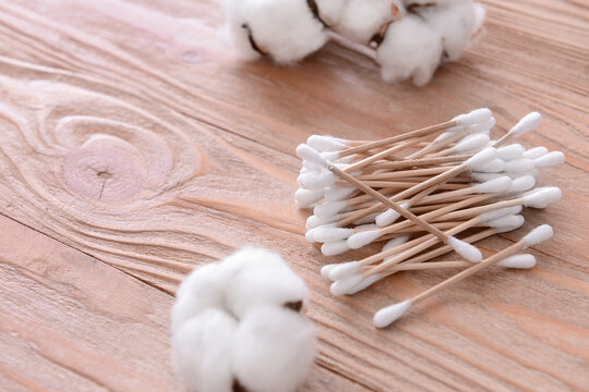 Cotton flowers with cosmetic swabs on table