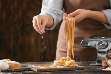 Woman preparing pasta in kitchen, closeup