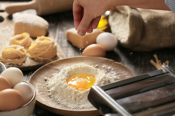 Woman preparing pasta in kitchen, closeup