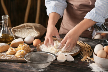 Woman preparing pasta in kitchen, closeup