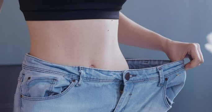 Successful weight loss woman with jeans at home