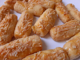 Kaasstengels or Kastengel or Kue Keju, is Dutch influenced-Indonesian cheese cookie in the form of sticks. Isolated in white background