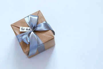 gift in craft packaging  on white background for Father's Day, give, a gift for the holiday, for dad