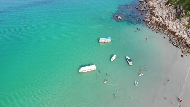 Aerial view of Binh Hung island with tourists, fishing boats, fishing villages and floating rafts raising seafood in Ninh Thuan province, Vietnam