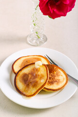 Pancakes with syrup and butter served