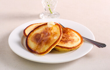 Pancakes with syrup and butter served