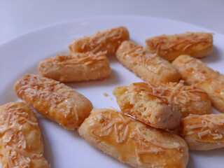 Kaasstengels or Kastengel or Kue Keju, is Dutch influenced-Indonesian cheese cookie in the form of sticks. Isolated in white background
