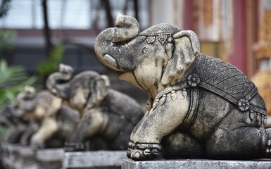 Fototapeta na wymiar Row of Elephant Statues with Trunks Raised, Wat Lamchang, Chiang Mai 2