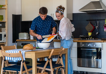 A couple cooking Italian food.