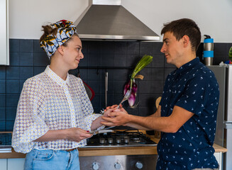 A couple cooking Italian food.