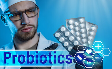 Probiotic. Doctor with pills in his hands on the background of the inscription Probiotics. Drugs...