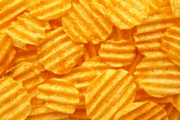 Rippled golden potato chips background with copy space for text