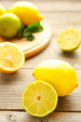 Fototapeta na wymiar Fresh ripe citruses with mint on grey wood table. Vertical