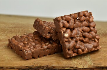 Nutrition, diet and junk food. Chocolate crispies sweets staked one next to the other.