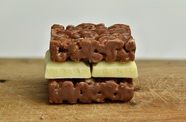 Nutrition, diet and junk food. Chocolate crispies sweets and white chocolate forming a chocolate sandwich