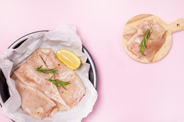 Preparation of Raw Squid and Ingredients on Black Plate Herb Citrus Top View Horizontal