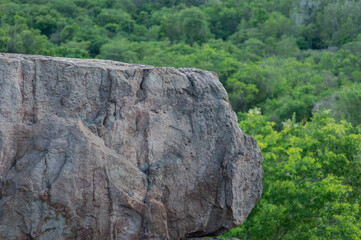 Large rock on the edge of a high cliff