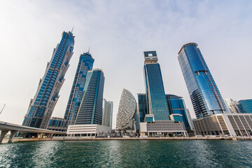Obraz premium Modern skyscrapers in Dubai. Business bay district. View from water canal. Futuristic architecture. 