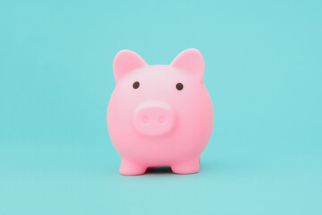 Blue piggy bank on blue background space for text. Savings concept.