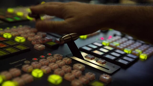 Broadcast Tv Studio Production - Vision Switcher 
Studio Director broadcast video mixer operation - Close-up of hand