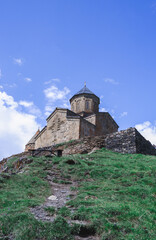 Fototapeta na wymiar Gergeti trinity church. Church at the top of a mountain in Georgia in Kazbegi. Mount Kazbek.