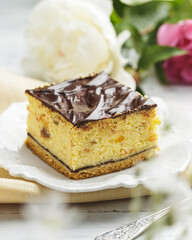 Piece of homemade cheesecake with chocolate glaze
