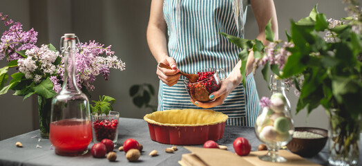 Cooking homemade cranberry pie. In the baking dish with the dough, put a spoon of fresh cranberries