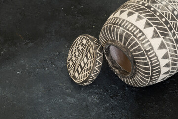 The black and white ceramic cruse on the background.