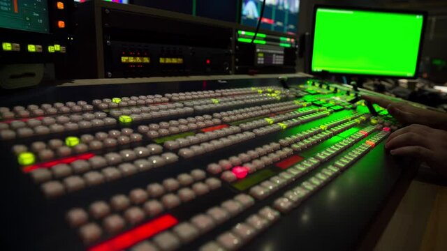 Broadcast Tv Studio Production - Vision Switcher 
Studio Director broadcast video mixer operation - Close-up of hand