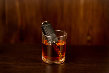 Whiskey with car keys and handcuffs. Concept for drinking and driving.