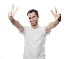 young casual man showing the victory gesture