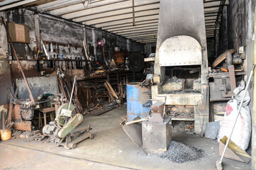 Fototapeta na wymiar Traditional blacksmith using manual method still available until now.