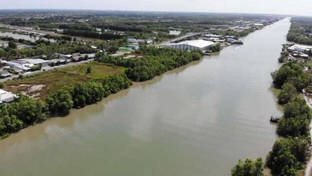 Aerial view of Cua Lon river in Ca Mau cape (Milestone Southernmost) of Vietnam. The boats turn water between green areas of Ca Mau countryside.
