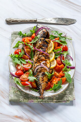 Grilled mackerel in spicy coating with fresh salad