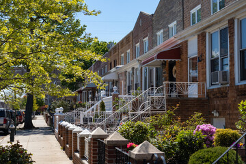 Row of Old Brick Homes with Beautiful Spring Gardens in Astoria Queens New York
